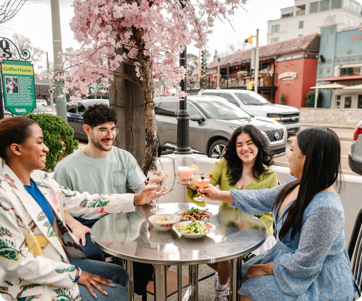 Guests enjoying drinks and Sichuan dishes on the patio